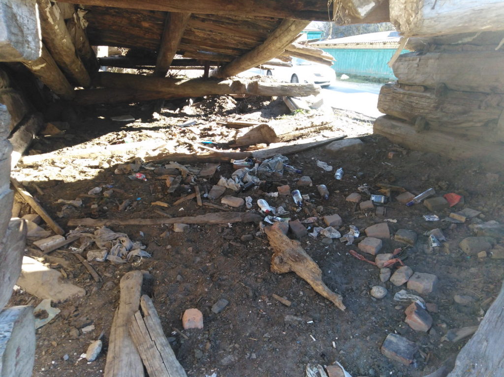 Abandoned house interior. Archaeologization process of debris accumulation.