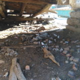 Abandoned house interior. Archaeologization process of debris accumulation.
